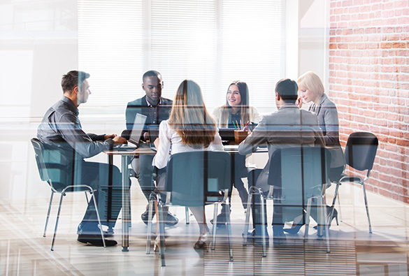 Group of people having a meeting around a table in an office.