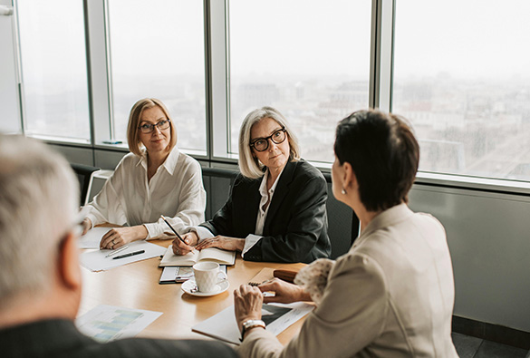 People having a meeting around a conference table in an office.