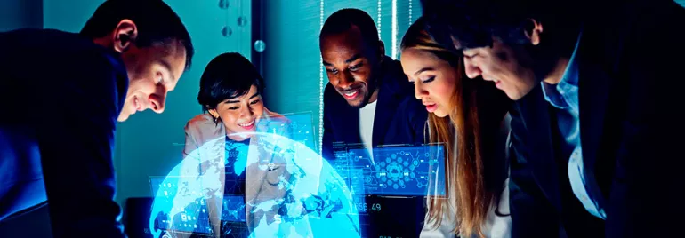 Group of people collaborating around a digital globe projection.