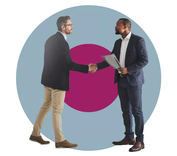 Two people shaking hands in a professional setting.