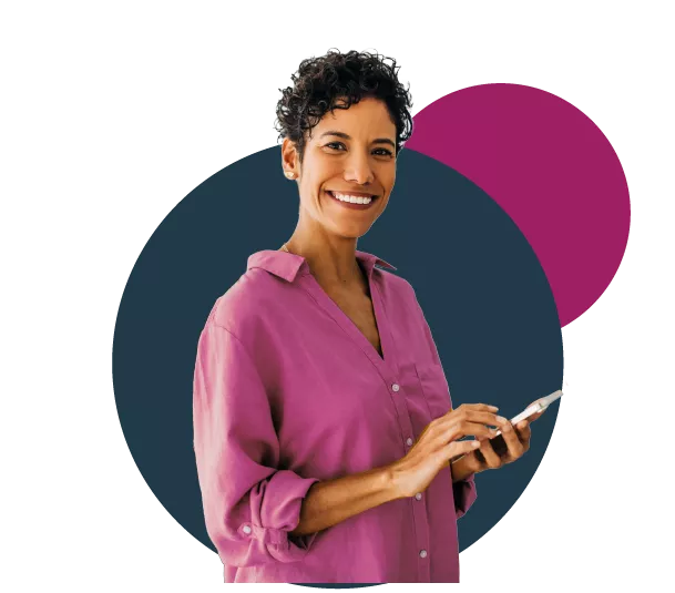 Person smiling while holding a smartphone, wearing a purple shirt.