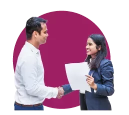 Two people shaking hands and smiling, one holding documents.