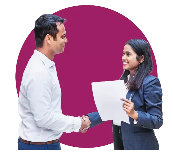 Two people shaking hands, one holding a document.